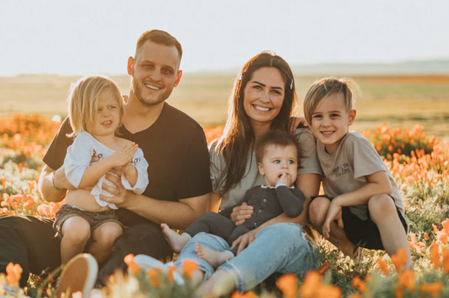 Family sitting together in flowers photo | Life Insurance service